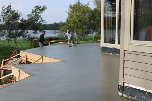 Workers finishing pouring concrete on the concrete deck built with LiteDeck.